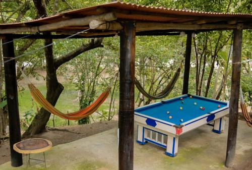 a playground with a pool table and a hammock at Mirador Dentro del Parque Tayrona in El Zaino