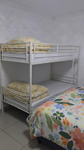two bunk beds in a room with a bed at Durban Overport Halaal Accomodation 5S in Durban
