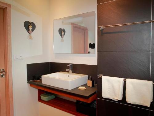 a bathroom with a white sink and a mirror at Unusual Hideaway in Lorraine in Métairies-Saint-Quirin