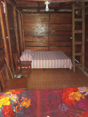 a small room with a bed and a ladder at Cabañas Las Yayas in San Pablo Número Dos