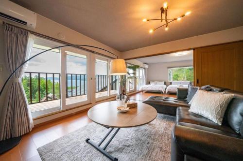 a living room with a couch and a table at Private Lodging HAN in Lake Toya
