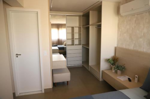a bedroom with a closet and a bed and a door at Ap de Alto padrão perto da feira da lua in Goiânia