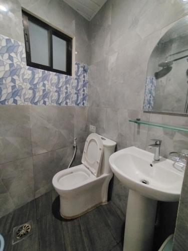 a bathroom with a toilet and a sink at Quirino hub (404) in Davao City