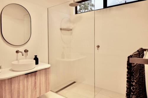 a bathroom with a sink and a shower at White Beach Retreat - Luxurious Water Views in White Beach