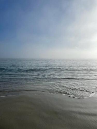 a beach with a body of water and the ocean at White Beach Retreat - Luxurious Water Views in White Beach