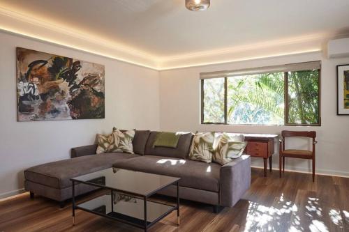 a living room with a couch and a table at Beachside Palm Beach Luxury - 2 Bedroom Apartment in Gold Coast