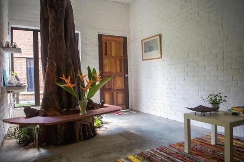 a room with a tree sitting next to a table at Langkawi Rouhi Retreats by uBook in Kuah