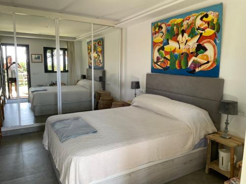 a bedroom with a bed and a painting on the wall at Finca vista de la roca in Estepona