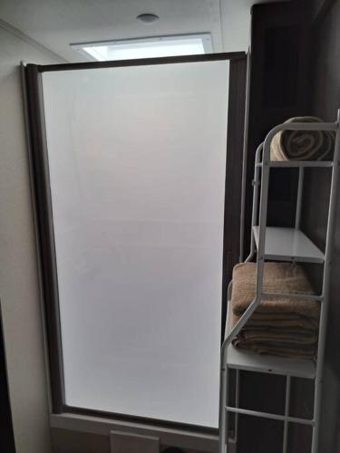 a large glass window in a room with a ladder at Sunset Trailer Park RV # 4 in El Suazal