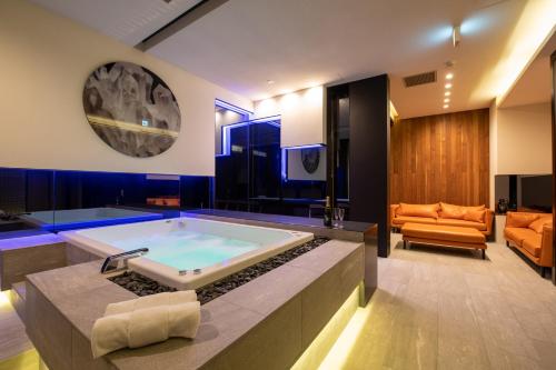 a large bathroom with a large tub in the middle at Nero in Kutchan