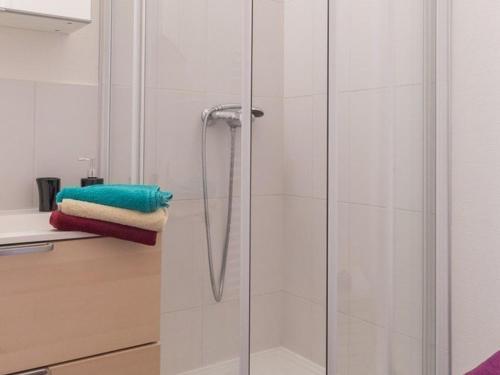a shower with a glass door in a bathroom at Studio rénové avec balcon sud, skis aux pieds, parking et grand jardin, La Salle-les-Alpes - FR-1-330F-237 in La Salle Les Alpes