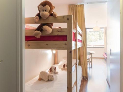 a bunk bed with two dogs laying on the floor at Studio rénové avec balcon sud, skis aux pieds, parking et grand jardin, La Salle-les-Alpes - FR-1-330F-237 in La Salle Les Alpes