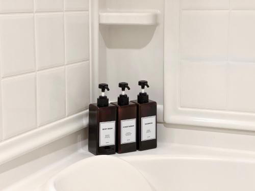 a group of three soap dispensers in a bathroom at Cozy Home in LA - Free Parking 10 Min to Cedars in Los Angeles