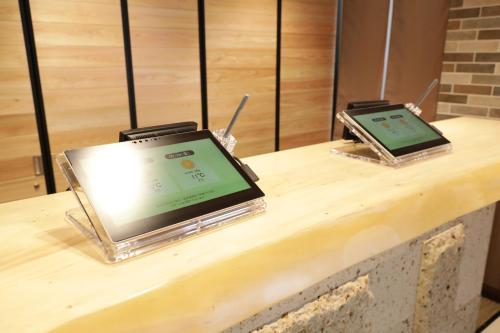two electronic devices sitting on top of a counter at Super Hotel Sano Fujioka in Sano