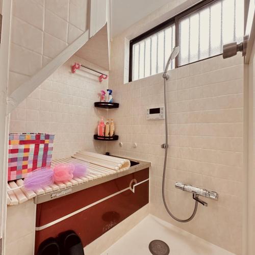 a bathroom with a shower and a sink at 花乃郷 西池袋 in Tokyo