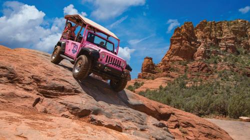 a pink jeep jumping off of a rock at Holiday Inn Express Sedona - Oak Creek by IHG in Sedona