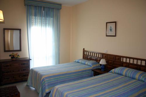 Krevet ili kreveti u jedinici u objektu Apartamentos Benal Beach - Geinsa