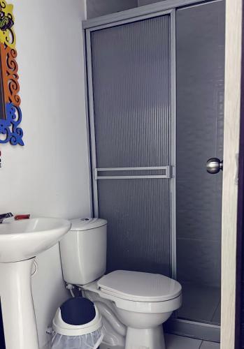 a bathroom with a toilet and a sink at HOTEl LAS FLORES in Santa Rosa de Cabal