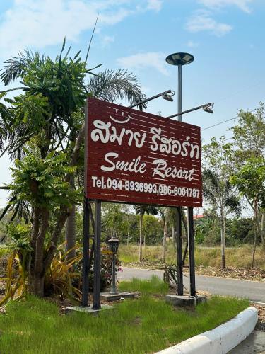 a sign for a smile resort on the side of a road at Smile Resort in Ban Phai Cham Sin
