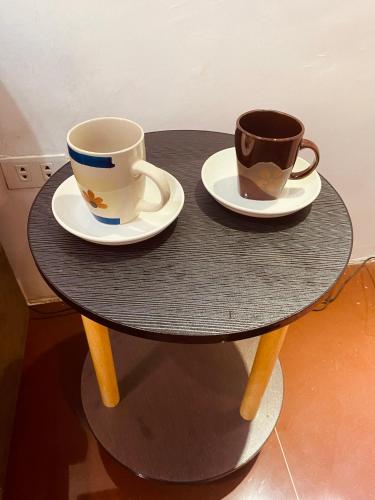 two coffee cups and saucers on a table at Chanver Guest House in Babak