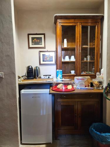 a kitchen with a white refrigerator and a counter at Il Vicoletto di BIBI - B&B in Staffolo