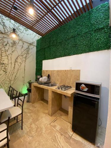 a kitchen with a counter with a sink and a stove at Casa de la Abuelita in Oaxaca City