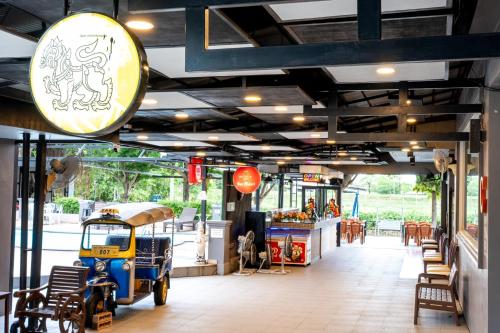 a restaurant with a car parked inside of it at The Great Residence Suvarnabhumi Airport in Lat Krabang