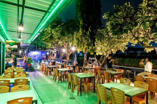 an empty restaurant with tables and chairs at night at The Great Residence Suvarnabhumi Airport in Lat Krabang