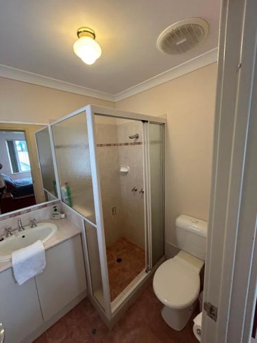 a bathroom with a shower and a toilet and a sink at Geraldton Luxury Vacation Home with free Streaming in Geraldton