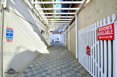 an alley with a car parked in a building at BN Tourist Home in Ooty