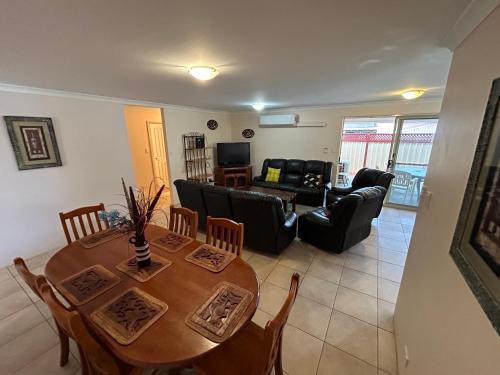 a living room with a table and a couch at Geraldton Luxury Vacation Home with free Streaming in Geraldton