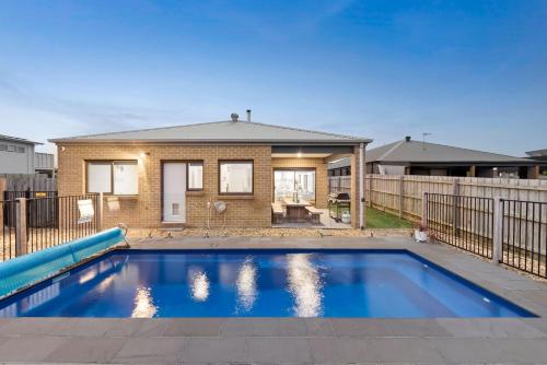 a swimming pool in front of a house at Thyme Out in Cowes