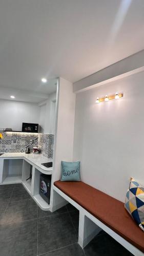 a room with a bench and a desk with a laptop at Homestay BỒ CÔNG ANH in Da Lat