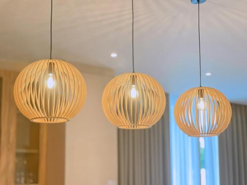 three lights are hanging from a ceiling at PNT LUXURY JOMTIEn in Jomtien Beach