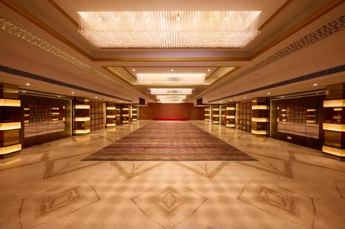 a large room with a long hallway with a rug at Delite Sarovar Portico Faridabad in Faridabad