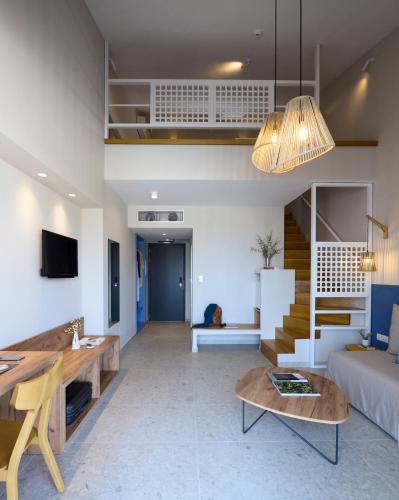 a living room with a couch and a table at Falena Luxury Rooms in Kalyves Poligirou