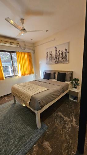 a bedroom with a large bed in a room at Lite Stays - Vile Parle East in Mumbai