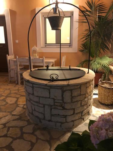 a circular stone bowl in a room with a table at Casa Ortensia in Kato Korakiana