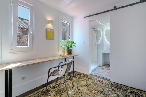 a home office with a desk and a chair at Sunny & Charming Oeiras Historical Center House in Oeiras
