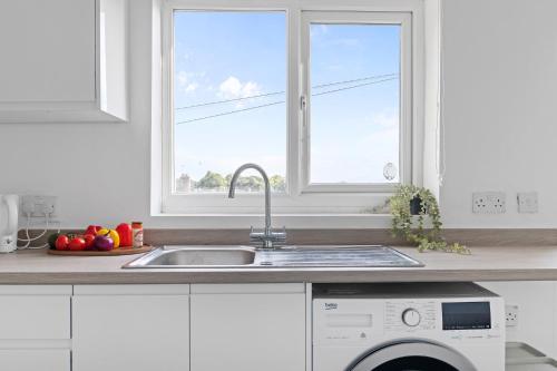 a kitchen with a sink and a window at JASIG APARTMENTS - Comfy 3 Bedroom house in Nottingham, Sleeps 6 in Nottingham