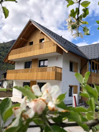 a house with a wooden roof at Vila Nina Bohinj in Bohinj