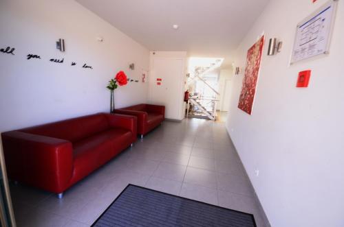 a living room with a red couch and a flower at Boutique & Villas Boliqueime in Boliqueime