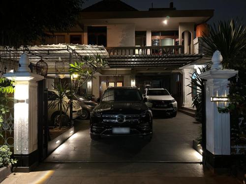 a car parked in front of a house at night at The Heritage Kraton Guest House in Timuran