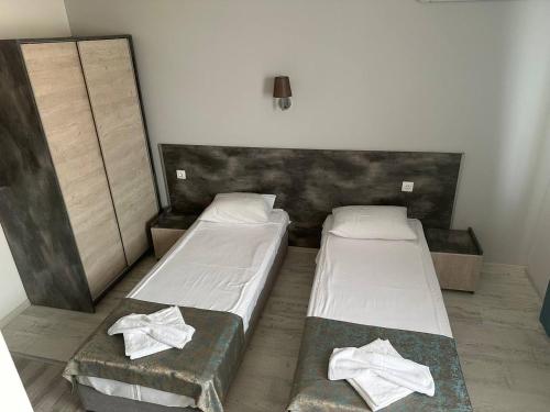 two beds in a small room with towels on them at Studios and Apartments Pomorie in Pomorie