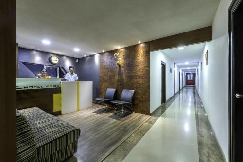 a hotel lobby with a man standing at a counter at Treebo Trend Edge St Marks Road in Bangalore