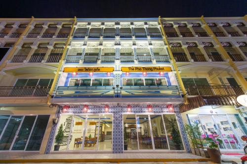 a building with a sign on the front of it at The Pho Thong Phuket in Phuket