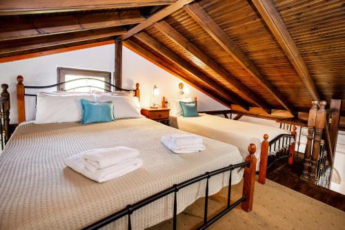 a bedroom with a bed with towels on it at Stone House Maria in Skala Marion