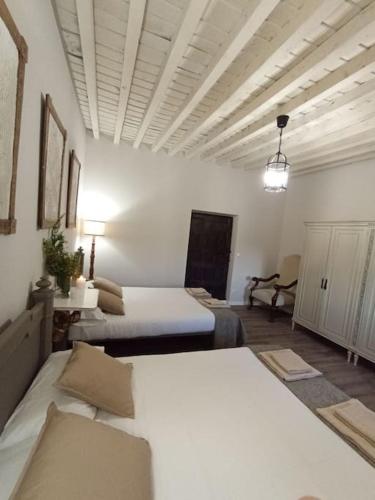a large room with two beds in a room at Casa Mayor in Huérmeces
