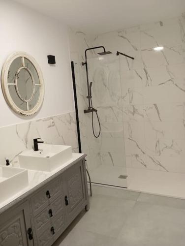 a bathroom with a shower and a sink and a mirror at Casa Mayor in Huérmeces