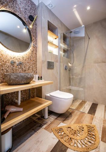 a bathroom with a toilet and a sink and a shower at Stone House Maria in Skala Marion